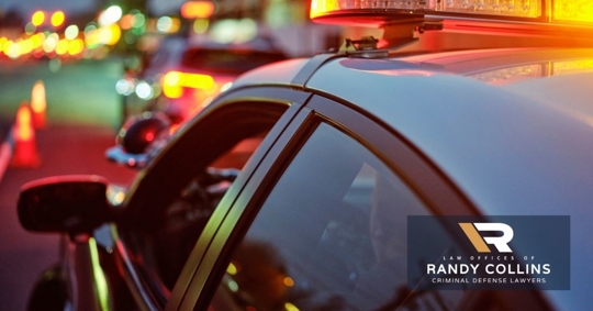 DUI stop with police lights, cones, and a car pulled over