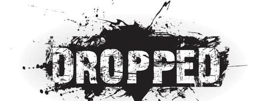 "Dropped" in big letters with black paint splattered around it