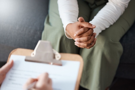 Cropped shot of an unrecognisable woman sitting with her psychologist during a consultation.