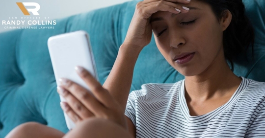 woman frustrated holding phone, hand on head and eyes shut